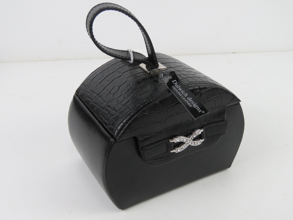 A contemporary black leather jewellery case having various compartments within. 15 x 10.5 x 21cm.