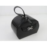 A contemporary black leather jewellery case having various compartments within. 15 x 10.5 x 21cm.