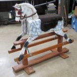 A vintage rocking horse having been naively refurbished.