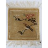 A hand knotted miniature prayer rug having bird and tree blossom upon, 32 x 30cm.