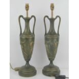 A pair of large classical style table lamps in the form of Grecian urns, having Bacchus decoration