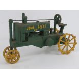 A reproduction vintage style cast metal John Deere tractor measuring 30cm in length.
