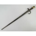 A French 1874 pattern Gras bayonet with scabbard, engraved to spine "Mre d'Armes de St.