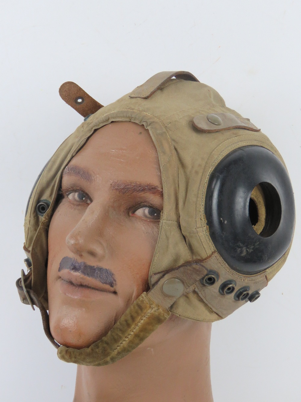 A US AN-H-15 soft flight helmet with chin strap.