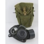 A WWII British Special Forces gas mask with filter and gas mask bag, dated 1944.