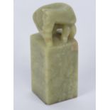 A 19th century Oriental square shaped jade seal surmounted with carved horse upon,