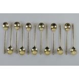 A set of twelve silver coffee spoons having barley twist handles and traditional Northern European