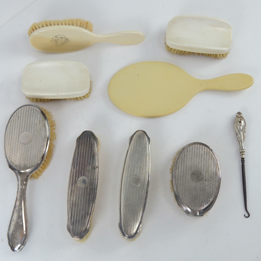 An HM silver dressing table set comprising hair brush and three clothes brushes.