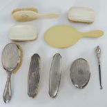 An HM silver dressing table set comprising hair brush and three clothes brushes.