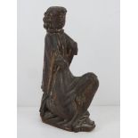 An ecclesiastical wooden carving of a robed man kneeling, a/f, 35cm high.
