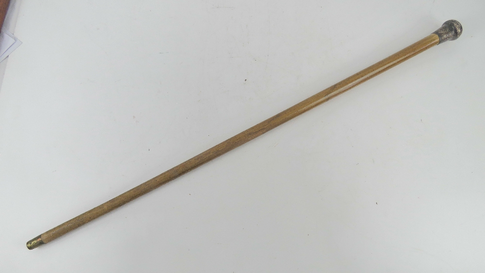 A swagger stick having white metal knop, top slightly a/f, no apparent hallmarks, 83.5cm in length.