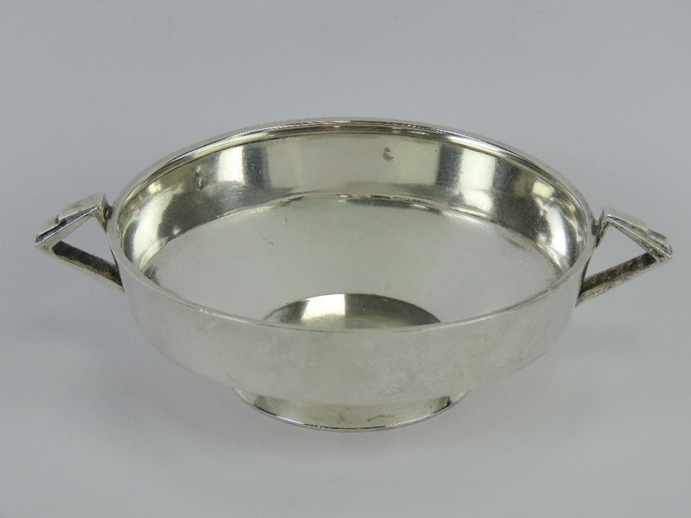 An Art Deco HM silver quaiche style single footed bowl having twin geometric side handles,