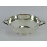 An Art Deco HM silver quaiche style single footed bowl having twin geometric side handles,