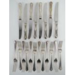 A set of HM silver dinner knives and forks for twelve settings by William Hutton & Sons Ltd,