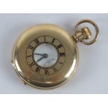 A gold plated top wind full Hunter pocket watch having viewing pane with black enamel chapter ring