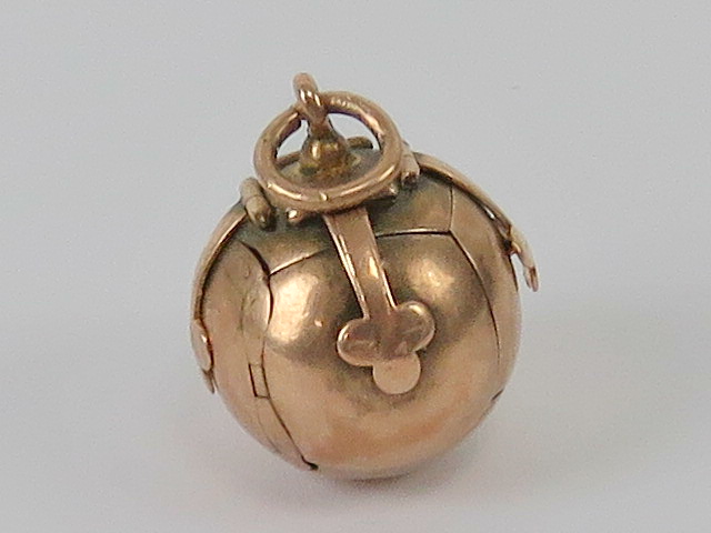 Freemasonry; a 9ct rose gold globe cross Masonic orb pendant,