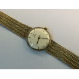 An Omega 9ct gold automatic wristwatch, cream dial with baton points,