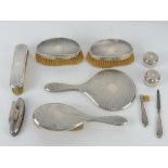 An HM silver dressing table set comprising mirror, hairbrush, two rouge pots,