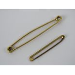A 15ct gold large 'safety pin' brooch, 6cm in length, stamped 15ct and weighing 3.6g.