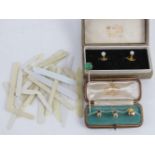 A matched pair of shirt studs, one marked 9ct, in fitted box,