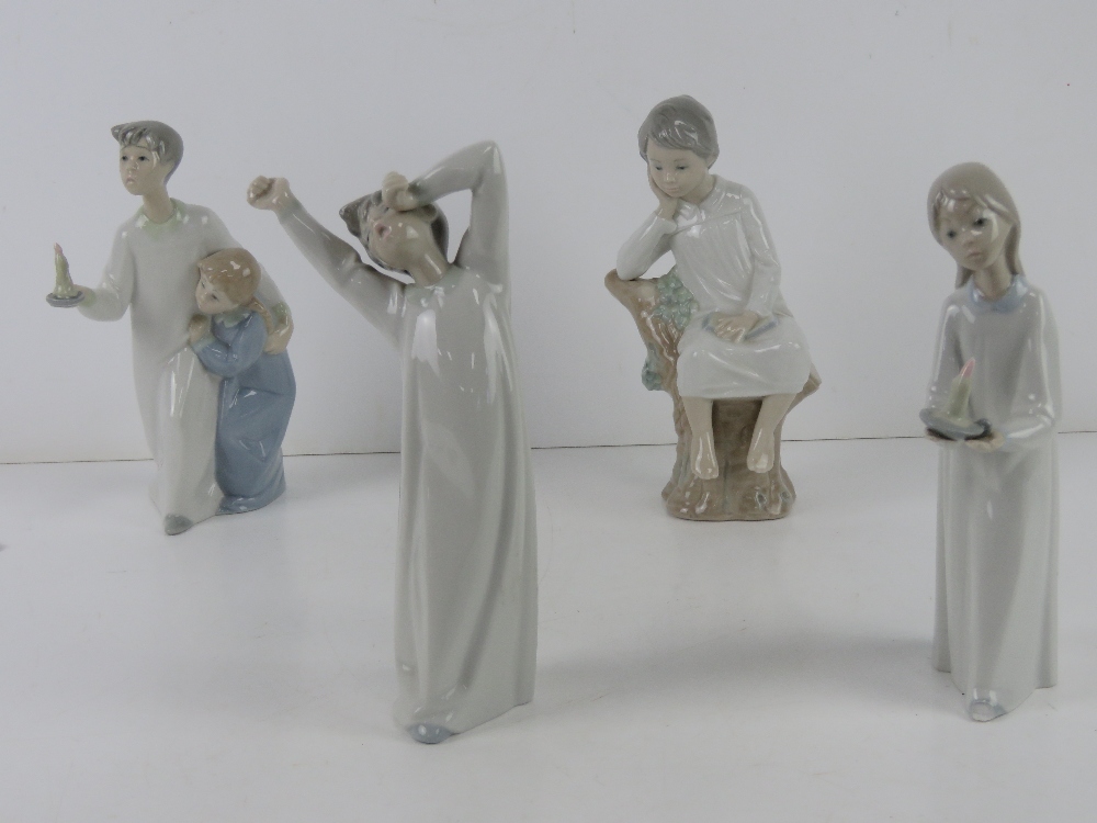 Lladro; Four figurines of children in night clothes, tallest approx 21.5cm high. One hand a/f.