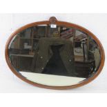 A good mahogany framed bevelled edge oval wall mirror with shell crest over, 77 x 55cm.