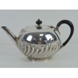 A Victorian HM silver teapot having ebonised wooden handle and finial,