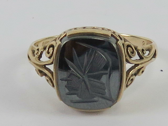 A 9ct gold hematite signet ring having carved centurion design upon, hallmarked 375, size T, 3.4g.