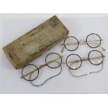 Three pairs of vintage faux tortoiseshell and yellow metal spectacles in original cardboard