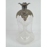 A late Victorian 'Glug glug' waisted decanter having overlaid silver decoration and spout,