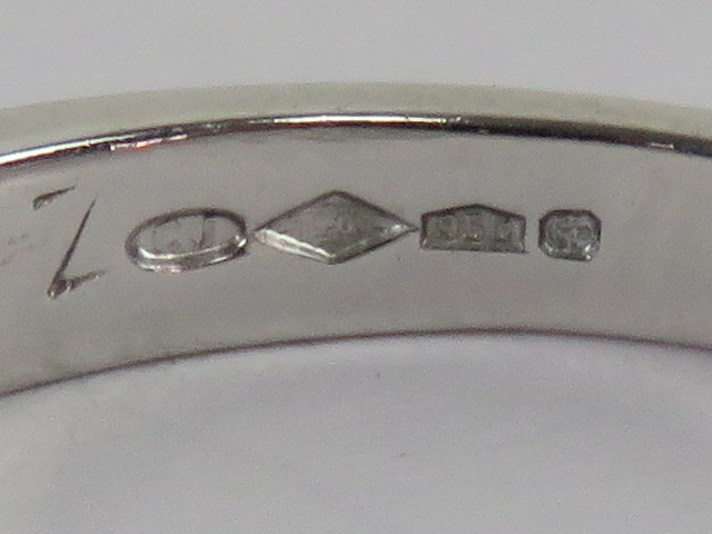 A platinum and diamond ring, central twist flanked by three round cut brilliant diamonds, - Image 2 of 3