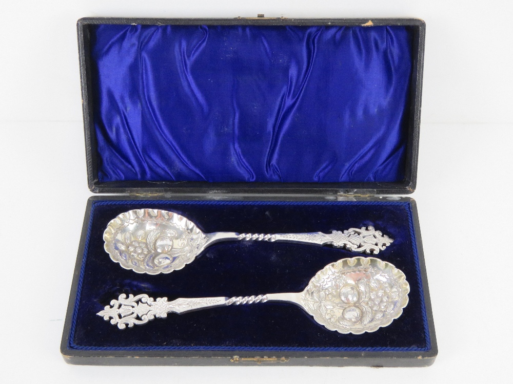 A superb pair of berry spoons in original velvet and silk lined fitted presentation box,