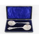 A superb pair of berry spoons in original velvet and silk lined fitted presentation box,