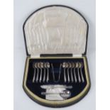 A cased set of silver plated teaspoons with cake knife and dessert spoon by Dickson,