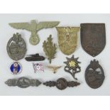 A quantity of assorted reproduction WWII German badges. Thirteen items.