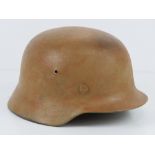 A WWII German M40 helmet having partial detail upon with liner and chin strap.