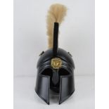 A reenactor or display piece Spartan helmet with natural coloured plume over.