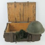 A British Military Turtle shell helmet with liner dated 1981. Together with a wooden transit case.