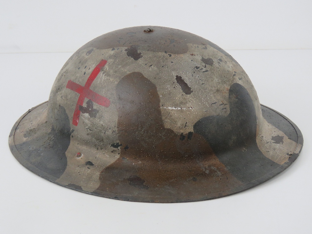 A WWI British Army Medics helmet, with liner and chin strap.