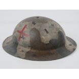 A WWI British Army Medics helmet, with liner and chin strap.