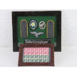 A reproduction WWII German armband. Framed WWII Hitler Stamps (24 stamps).