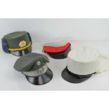 A Royal Marine dress cap (no badge, size 55), a French Foreign Legion Kepi (size 58 ½),