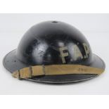 A WWII Brodie helmet FAP (First Aid Post) with liner and chinstrap.