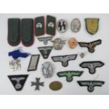 A quantity of assorted reproduction WWII German cloth patches, epaulettes, collar patches, etc.