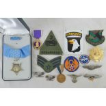 A quantity of assorted WWII USA insignia and medals including Medal of Honour and Purple heart.