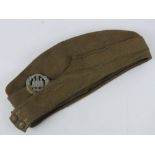 A WWII British Army forage cap with Northamptonshire cap badge dated 1943