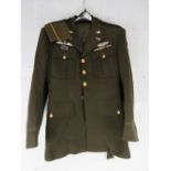 A US WWII tunic with insignia and side cap.