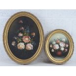 Two mid 20thC oil on canvas floral still life paintings in matched oval frames,