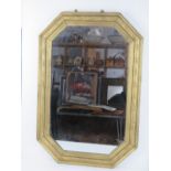 A large octagonal wall mirror having carved and gold painted wooden frame measuring 79 x 53.5cm.