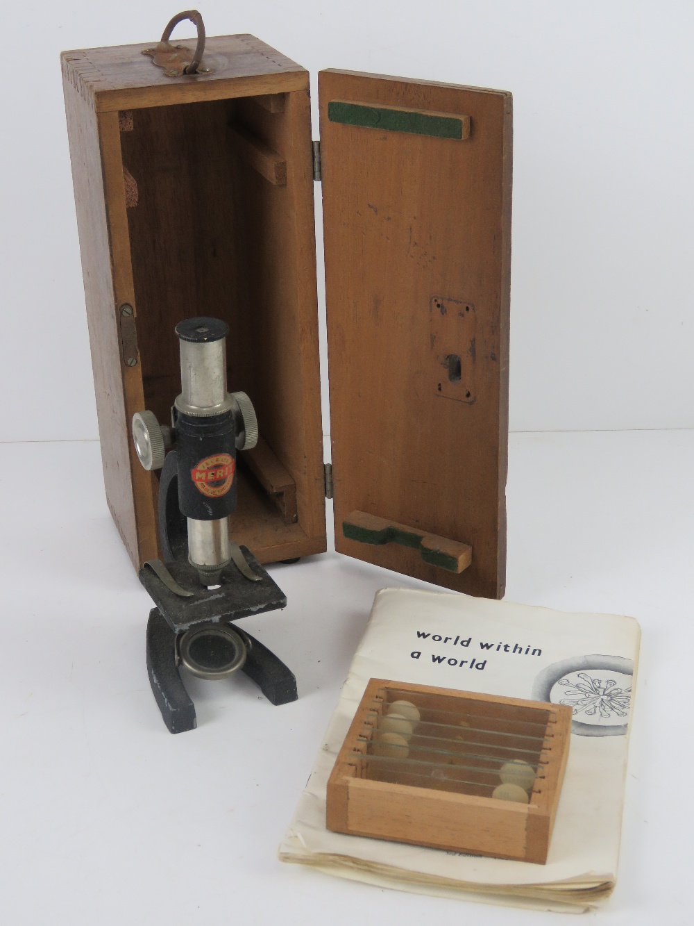 A Britex Pioneer II microscope in box with instructions and set of six slides.